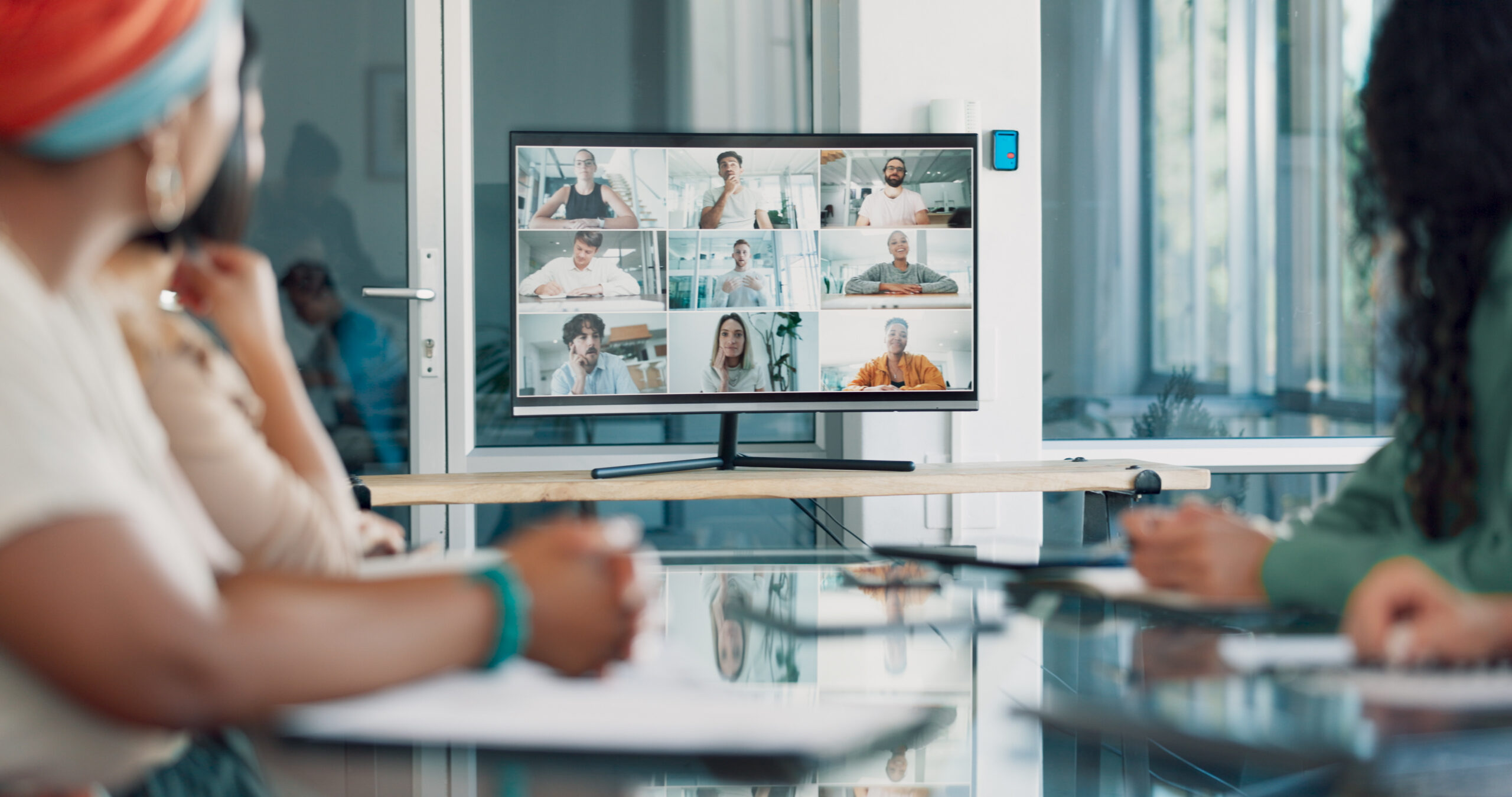 Professionals attending an online meeting in a workplace setting